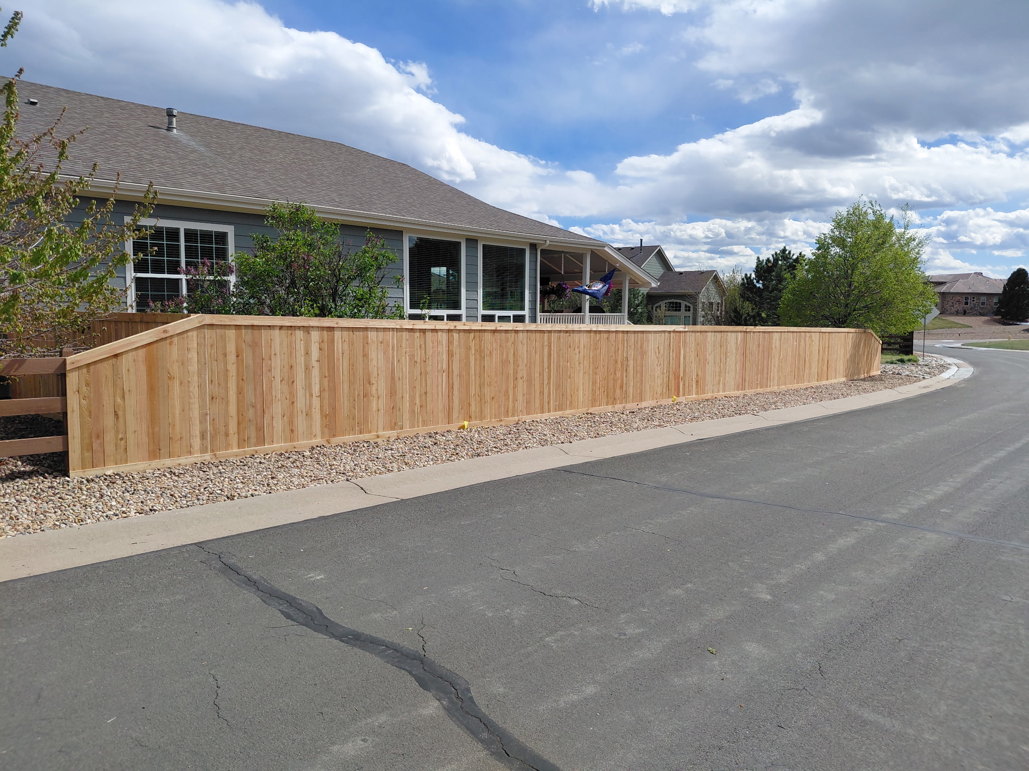 Custom cedar wood privacy fence installation along residential street in Parker, Colorado