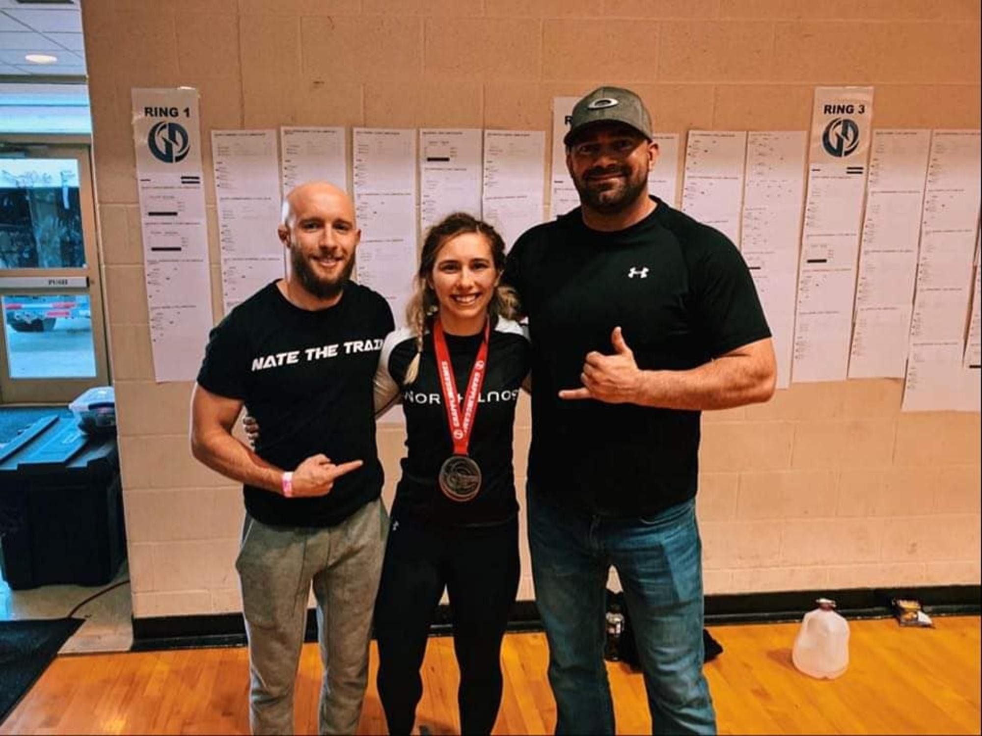 BJJ Tournament Clarksville TN Wildside — student celebrating a medal win with coaches