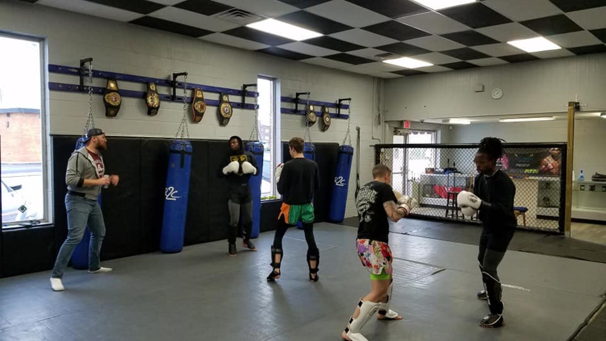 Martial Arts Clarksville TN Wildside — gym interior striking area and championship belts