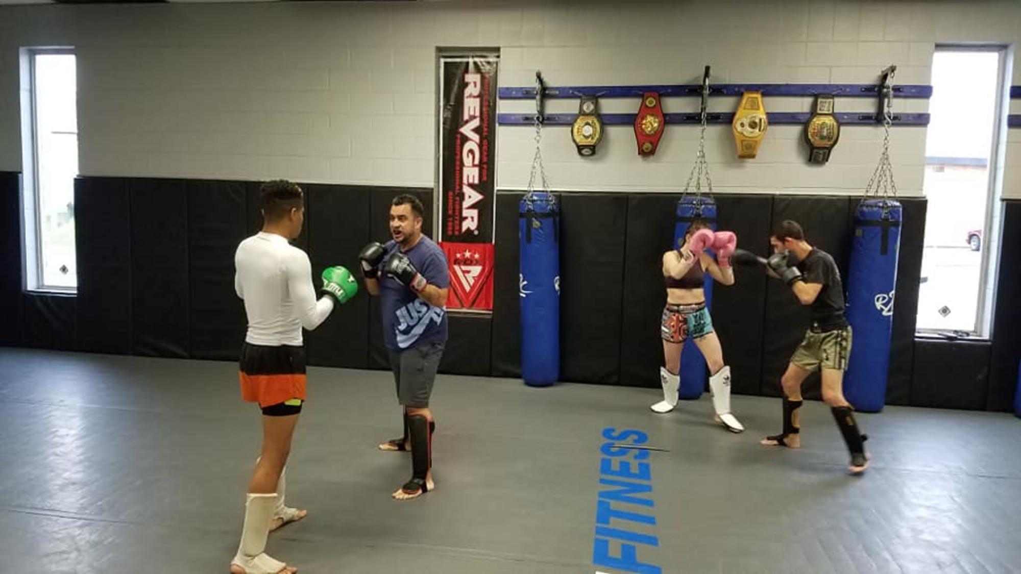 Striking Training Clarksville TN Wildside — students drilling kickboxing on pads