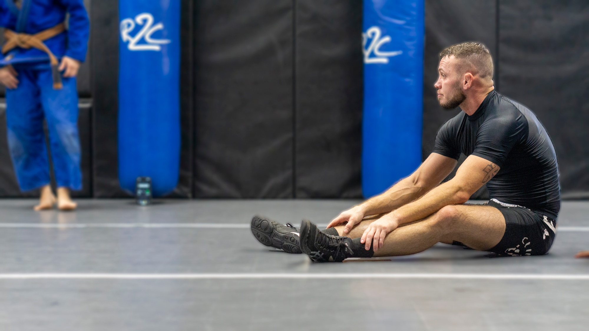 Martial Arts Clarksville TN Wildside — student stretching and recovering on the mats