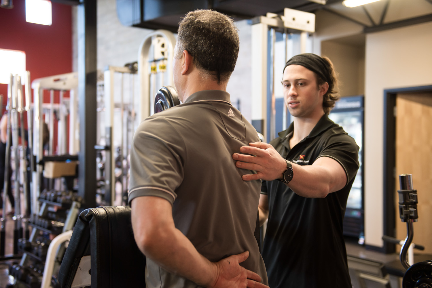 Momentum Performance coach giving hands-on guidance to a client at the private studio