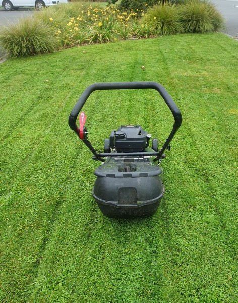 Mower on a freshly cut lawn with stripes