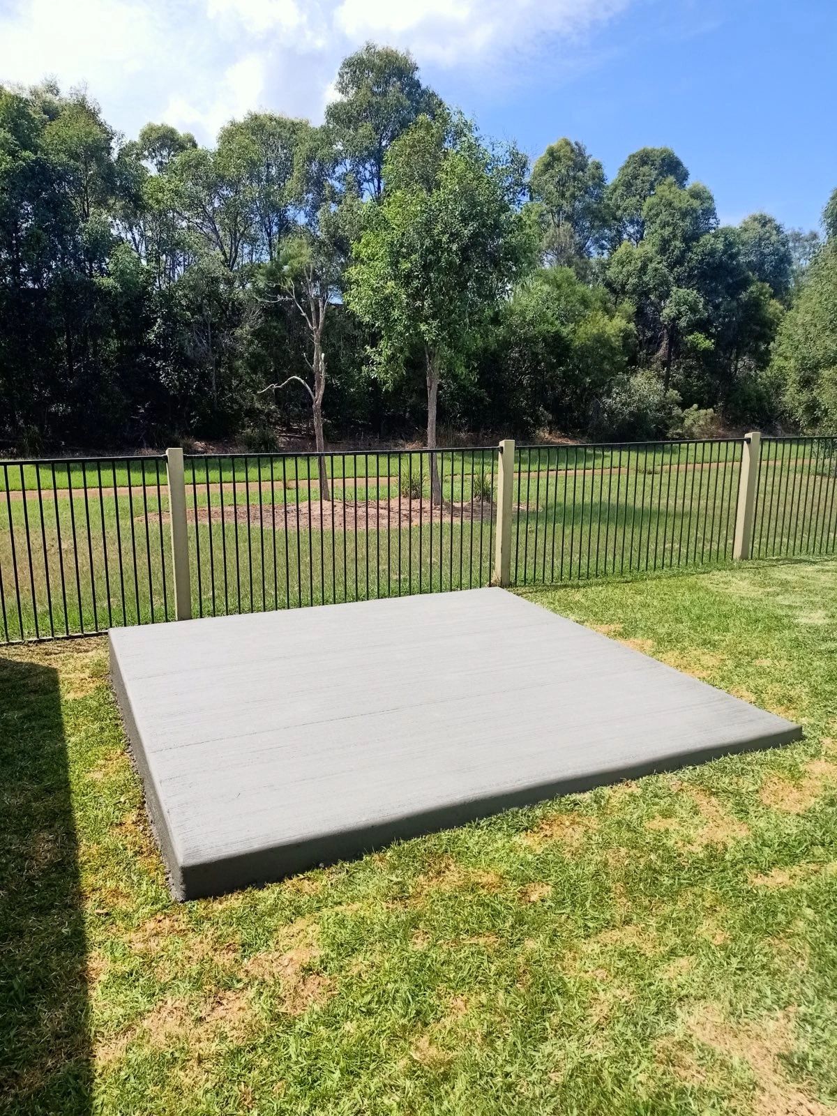 Freshly poured concrete garden shed base with neat edges in Moreton Bay