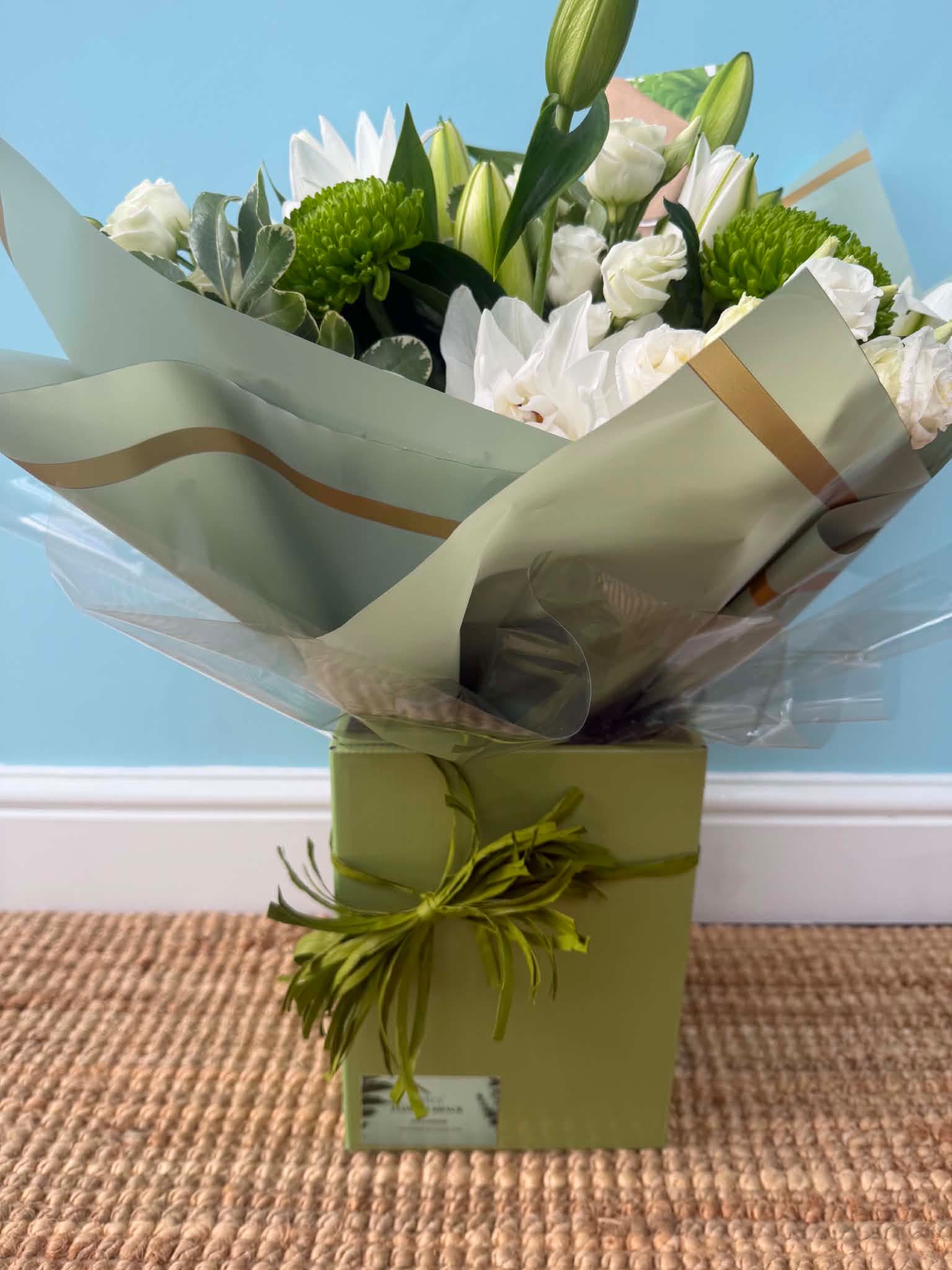 Lily's and Blooms bouquet — elegant white lilies and vibrant green blooms