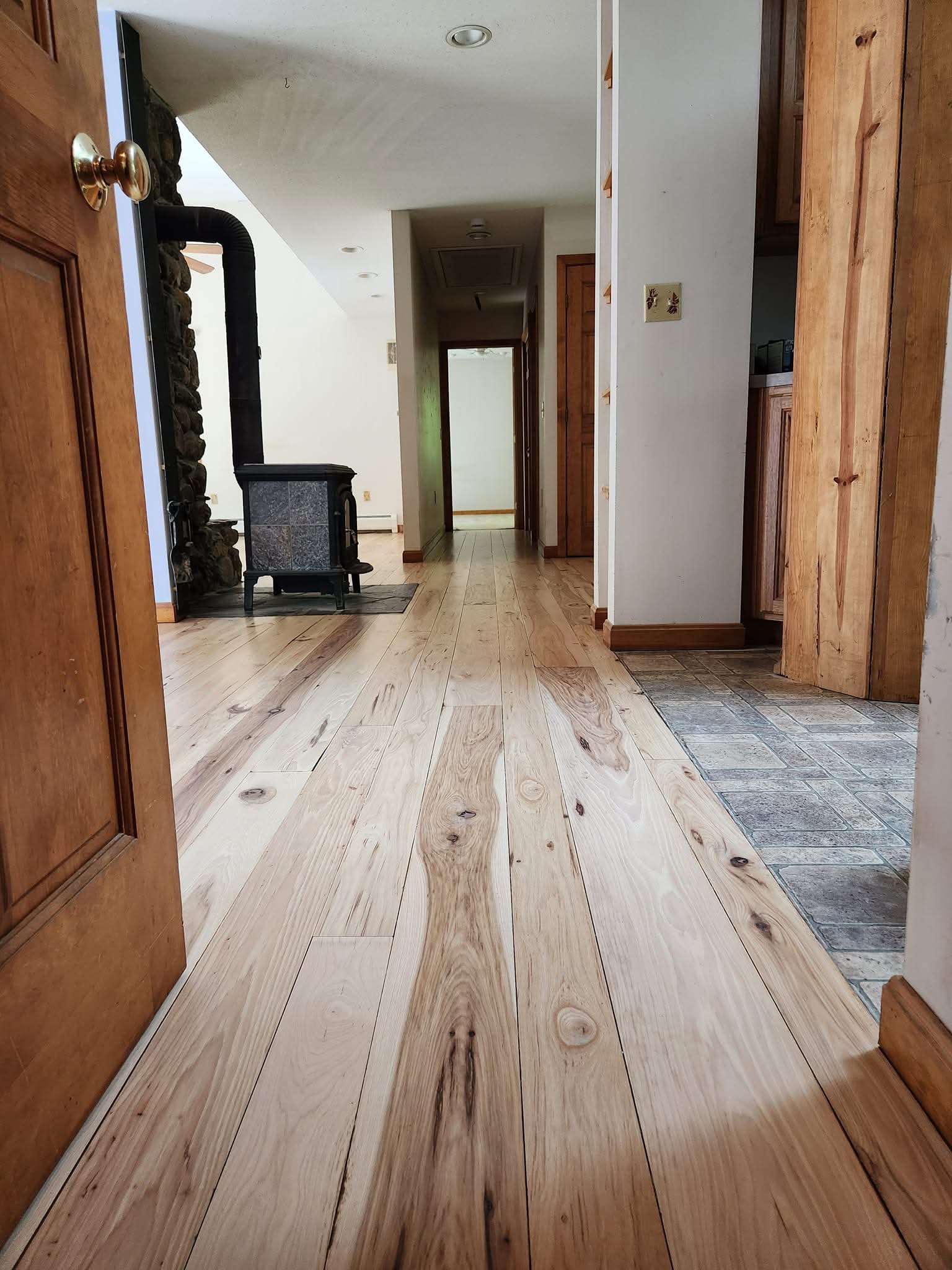 Newly installed hardwood flooring hallway by a fireplace