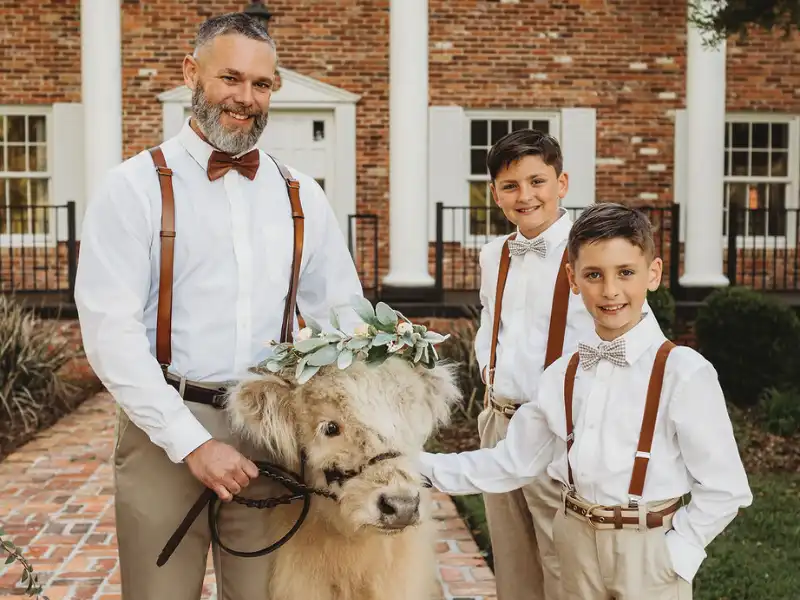 Groom and ring bearers with Highland cow