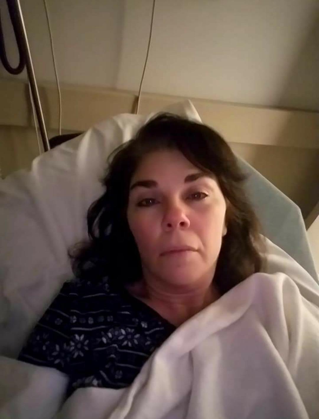Woman in hospital bed, looking reflective and weary, representing chronic health struggles and recovery journey.