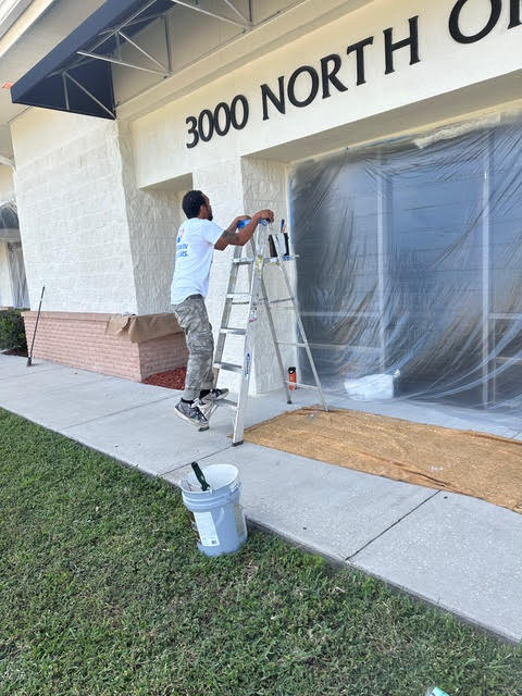 Professional painter working on commercial building exterior