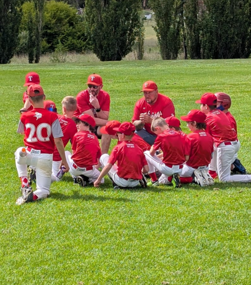 Vikings Juniors team huddle on field