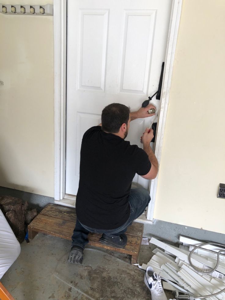 Locksmith working on residential door lock