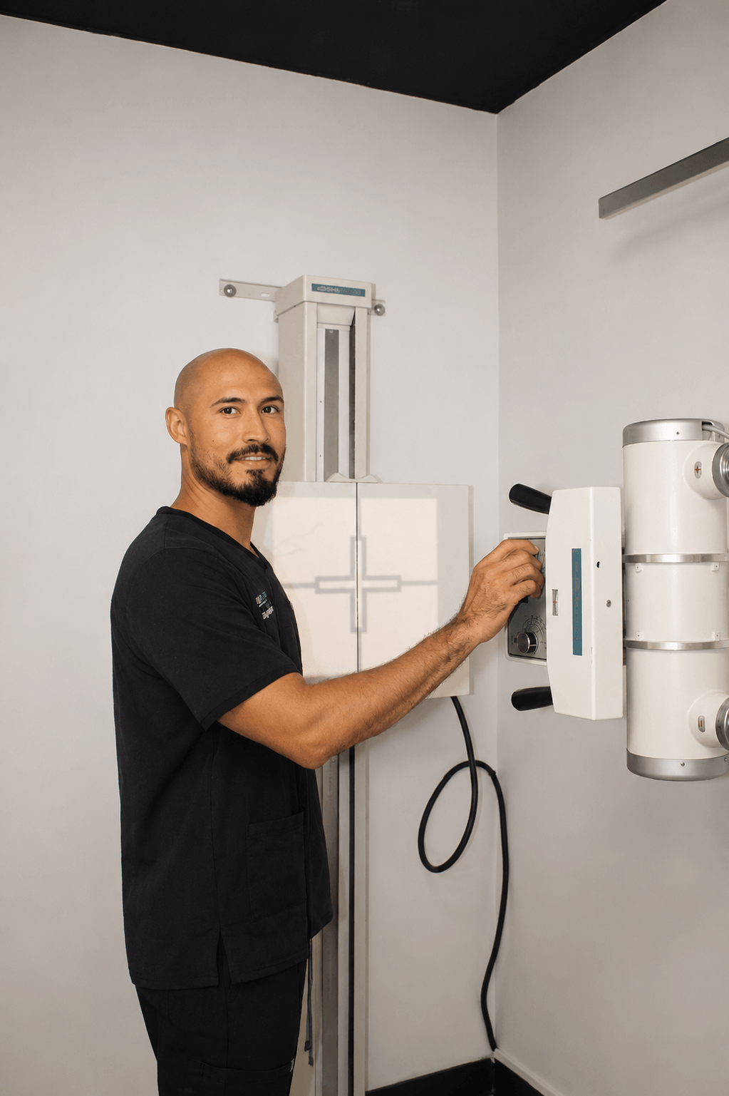 Dr. George Berbessi operating digital X-ray equipment for diagnostic evaluation at Back to Life Injury Centers in Gainesville, GA