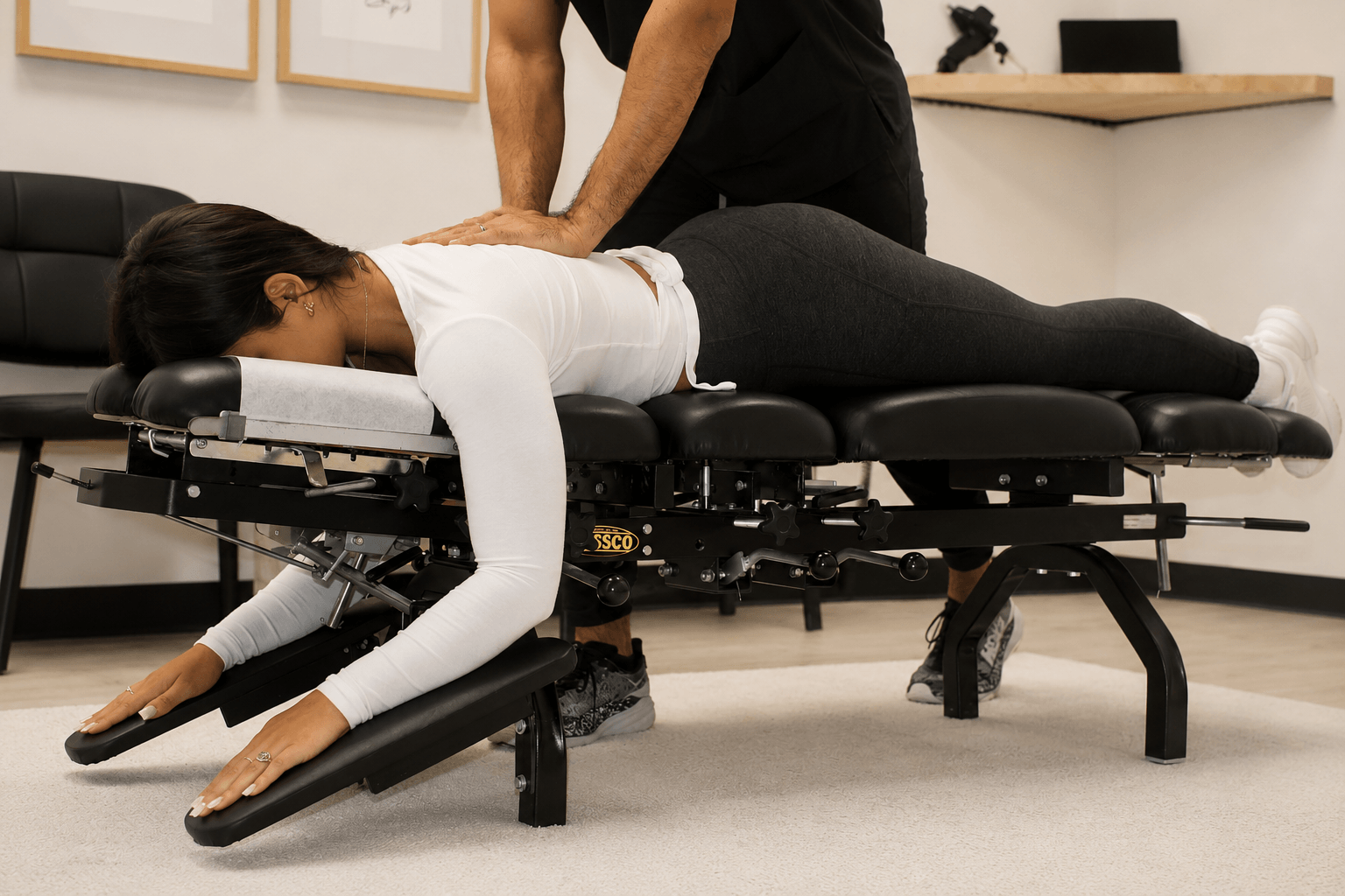 Dr. George Berbessi performing a hands-on chiropractic spinal adjustment on a patient at Back to Life Injury Centers in Gainesville, GA