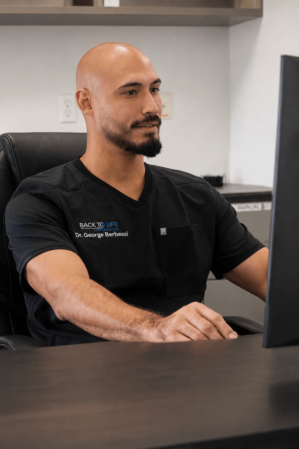 Dr. George Berbessi at Back to Life Injury Centers in Gainesville, GA providing personalized headache and migraine treatment consultations