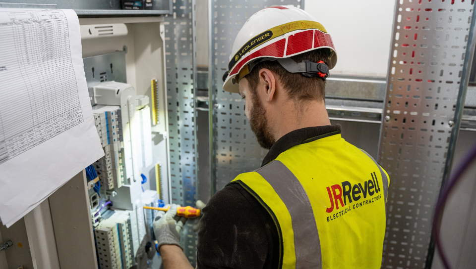 Engineer installing electrical panel