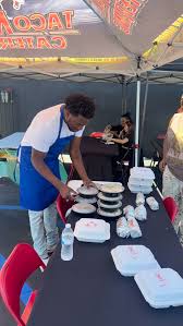 Taco Mell team member preparing fresh tacos at a catering event