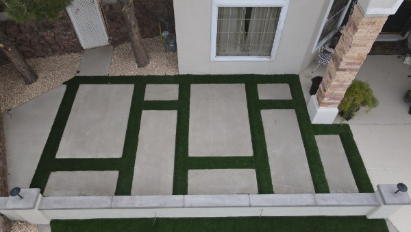 Modern turf and concrete paver design with custom geometric layout