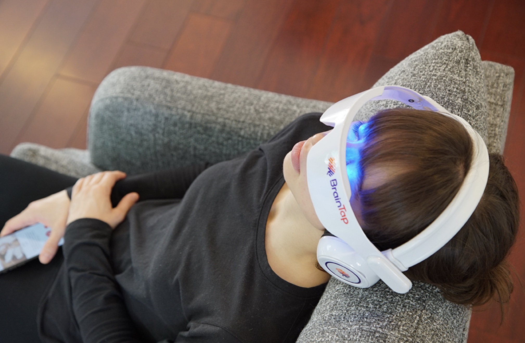 Person relaxing while using a BrainTap headset