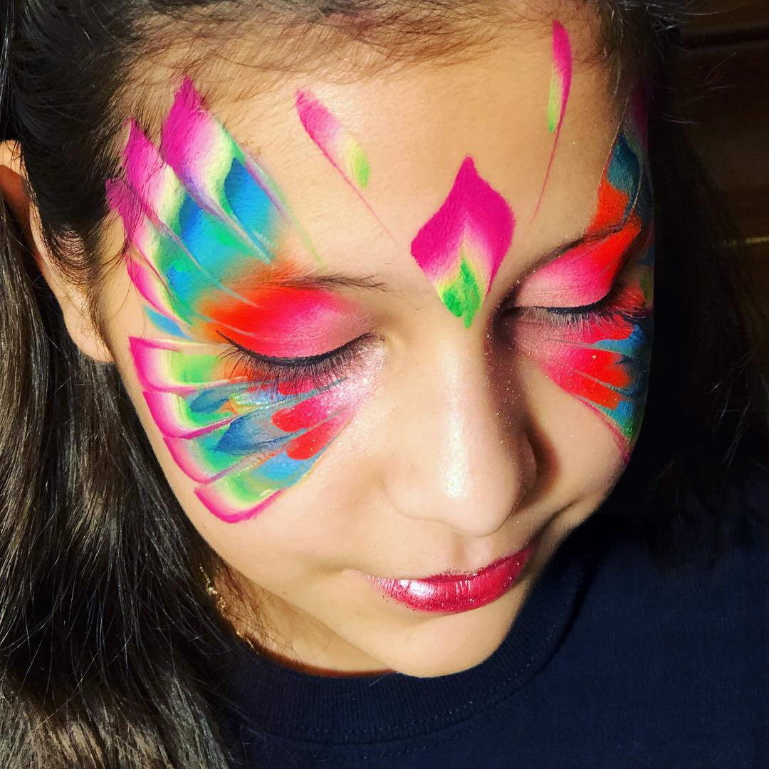 Colorful face painting design by Candy Pintacaritas at a Houston event