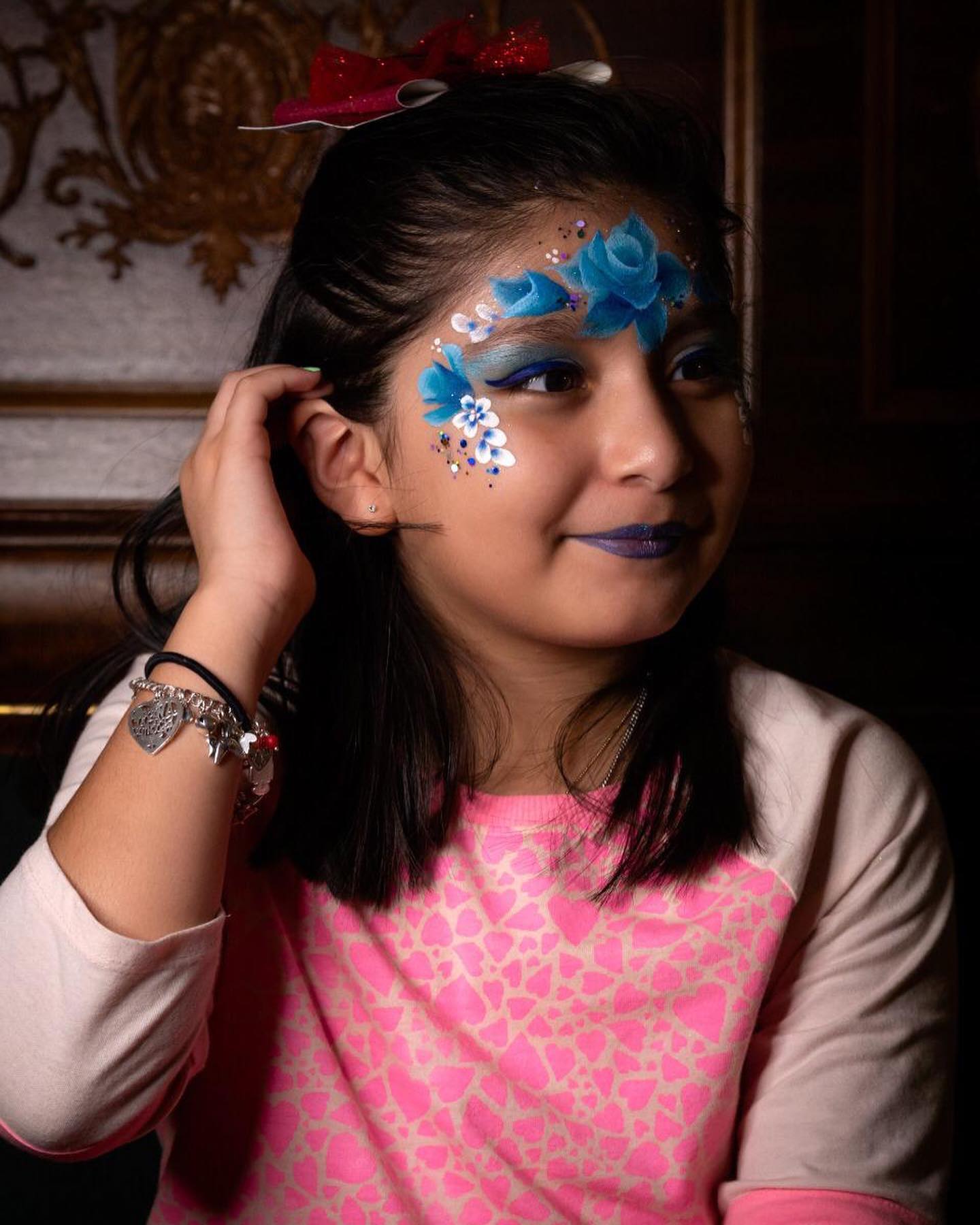 Smiling child showing off face paint at a Houston birthday celebration