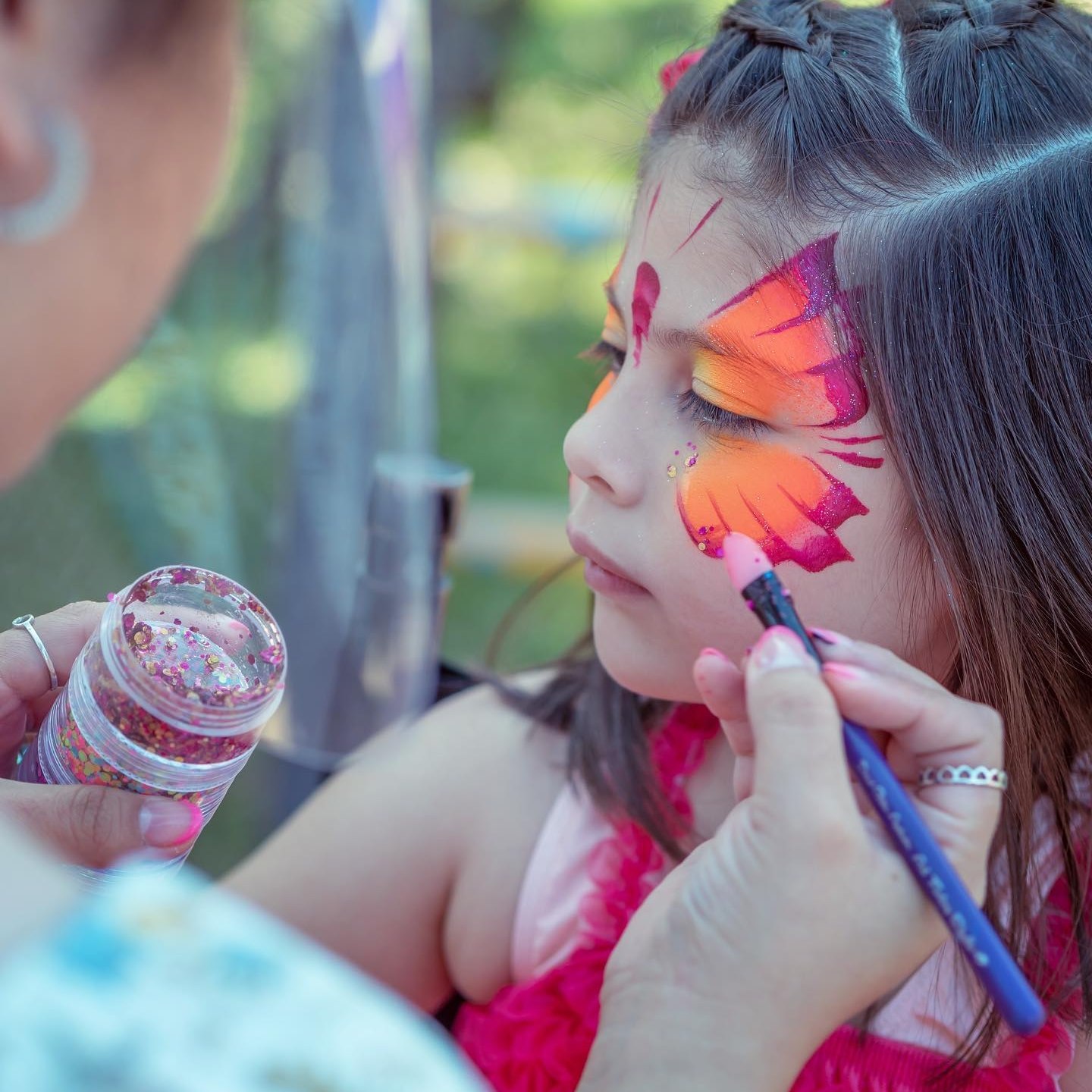 Kids enjoying face painting at a Houston school event