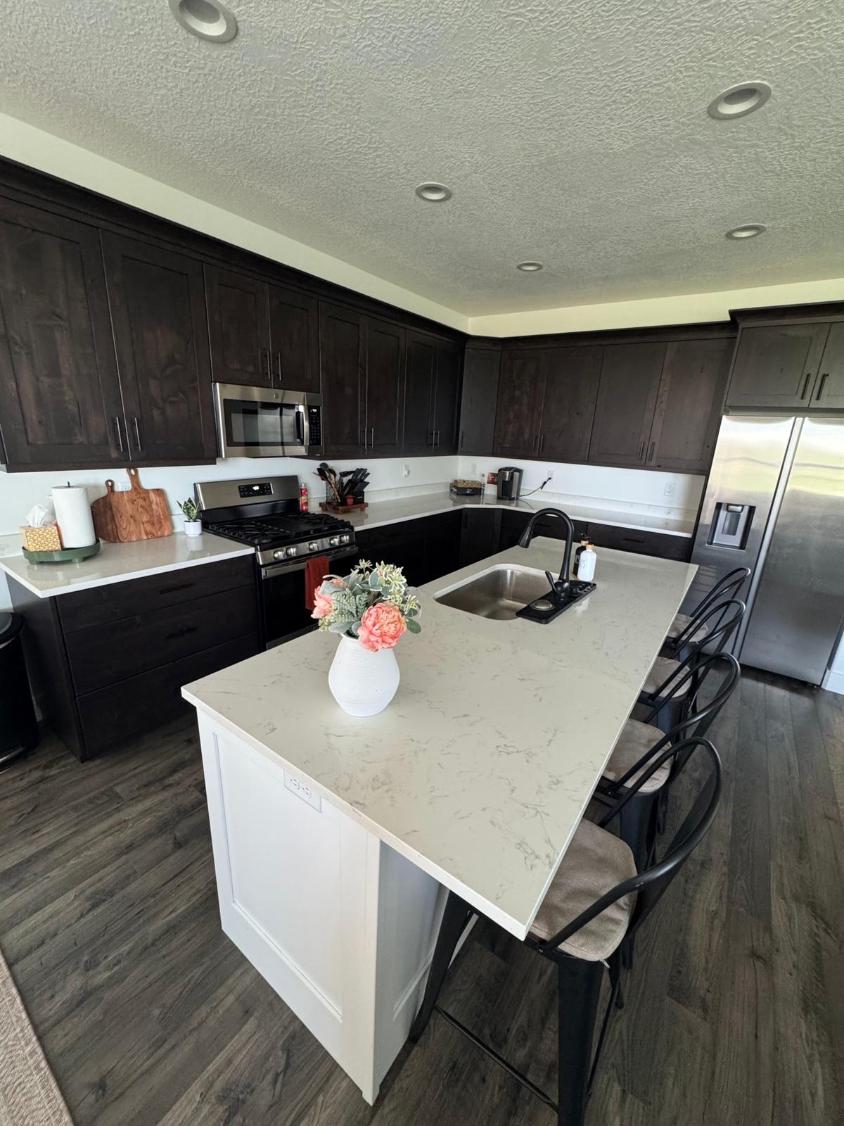 Full kitchen remodel with white shaker cabinets and quartz countertops completed by Alta Home Group in Draper Utah
