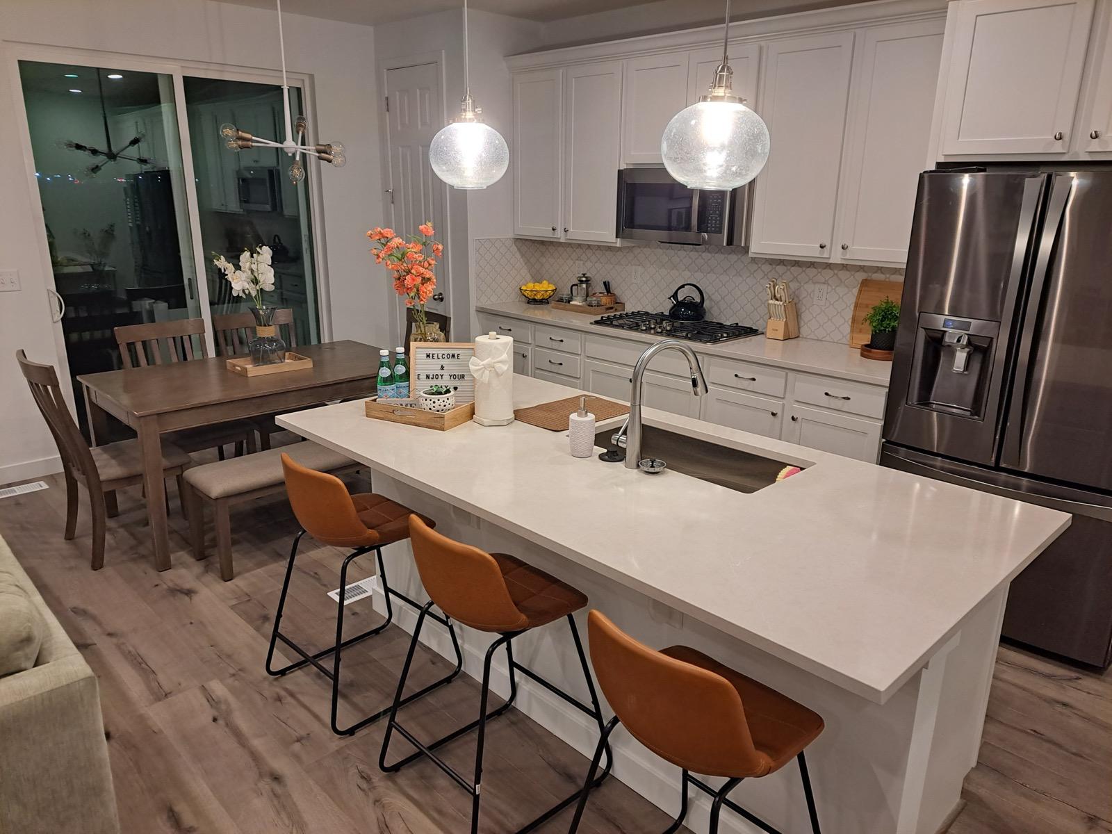 Open concept kitchen renovation with custom island and pendant lighting installed by Alta Home Group in South Jordan Utah