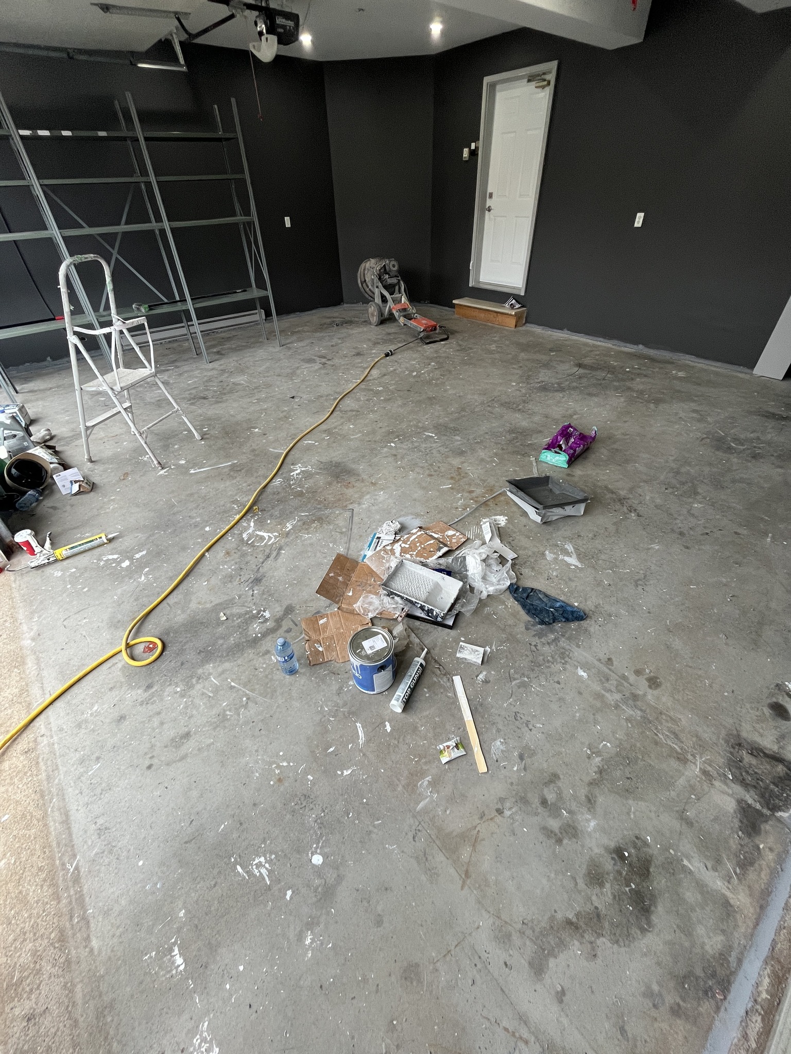 Before: Tired, stained bare concrete garage floor before epoxy coating