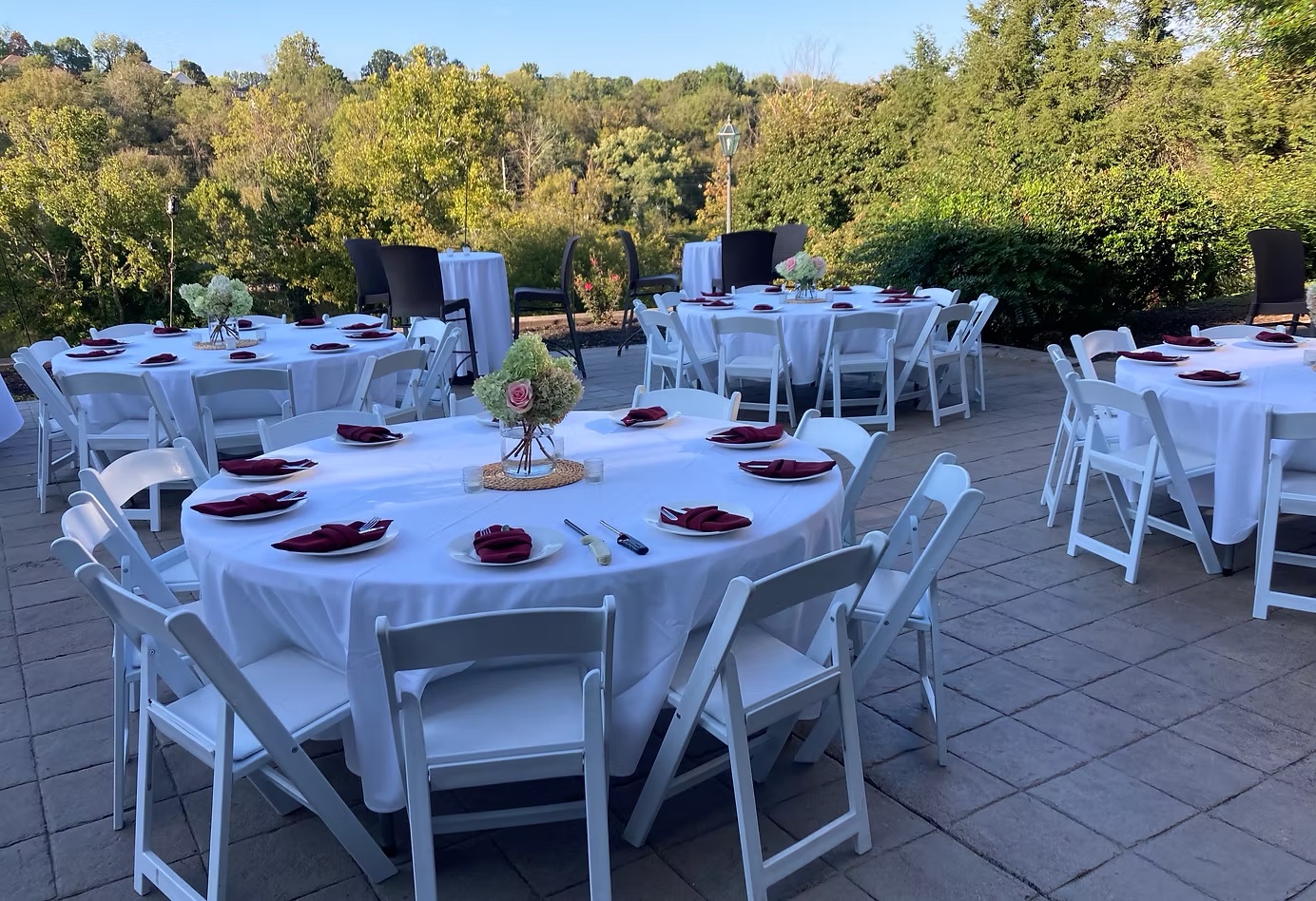 Outdoor event setup at Fusion at Ridgefields with round tables and white chairs