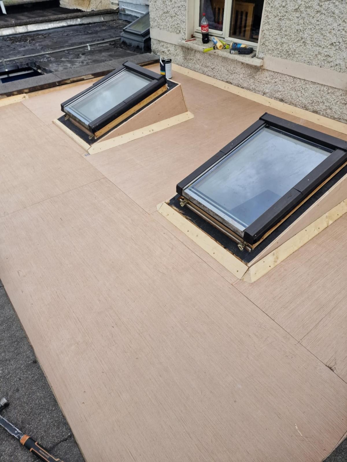 Existing roof windows re-kerbed on new timber upstands on a plywood flat roof deck in Walkinstown