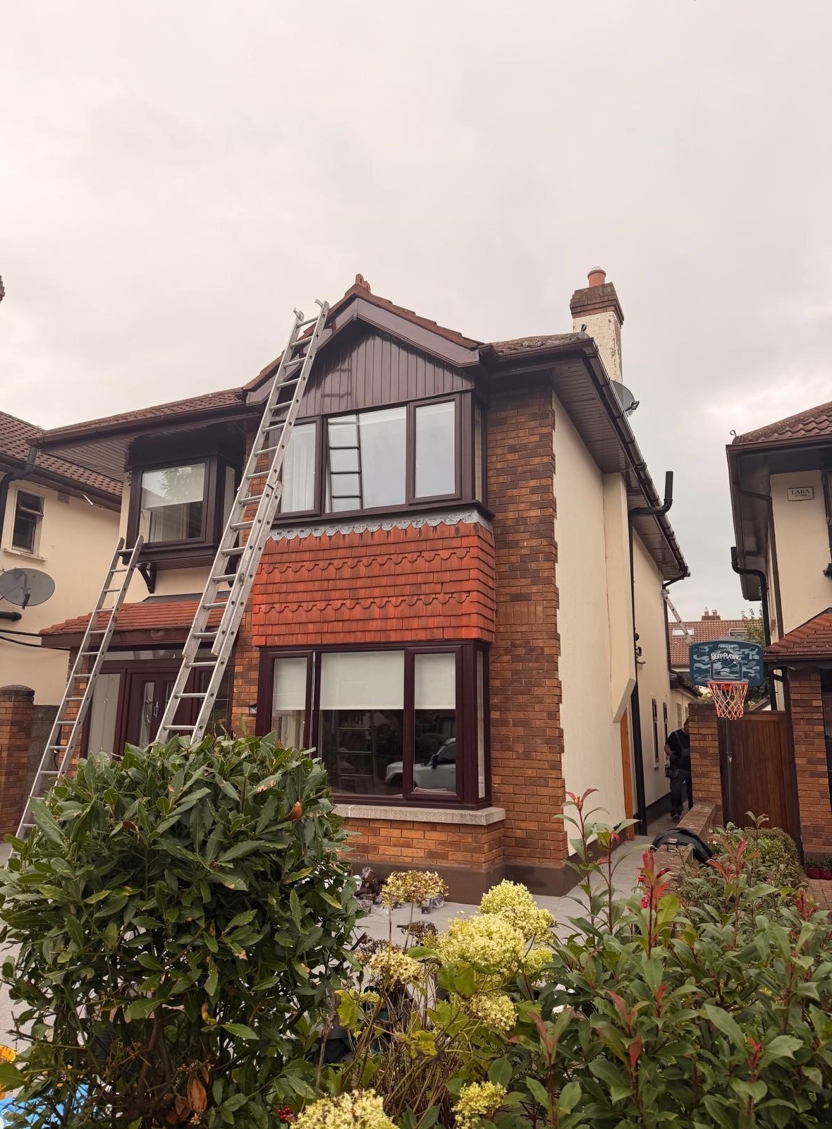 Side-angle view of completed brown fascia soffit and guttering replacement in Rathfarnham Dublin