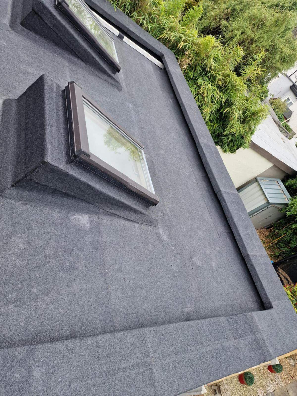 Torch-on felt dressed up a rooflight upstand and around the perimeter of a flat roof in Walkinstown