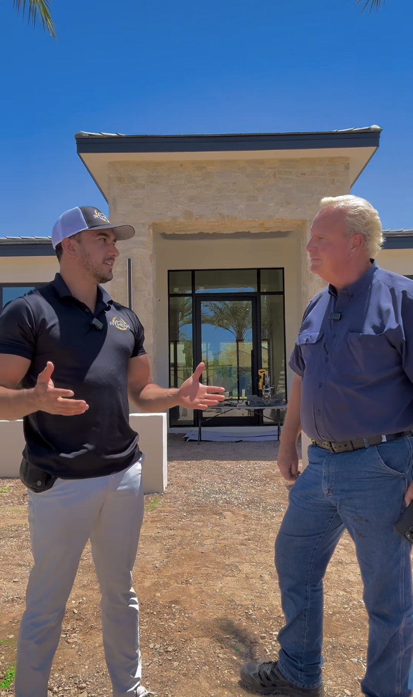 Two Athena Alliance industry professionals discussing a project at an Arizona construction site