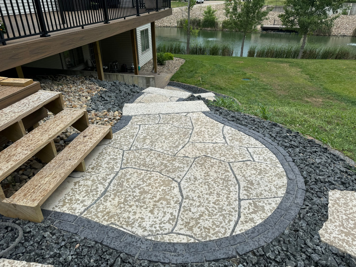 Bergman Nurseries custom stone paver walkway and steps near a pond