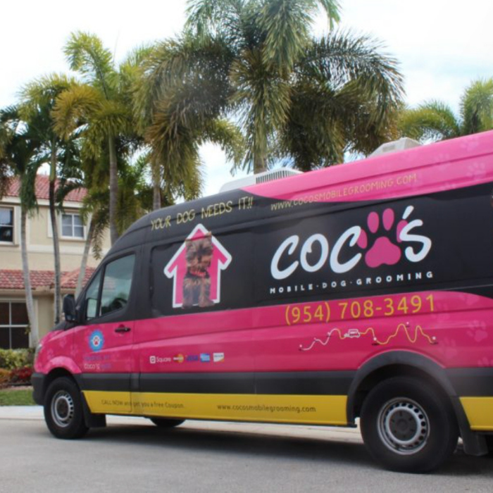 Coco's branded mobile grooming van parked outside a home in South Florida