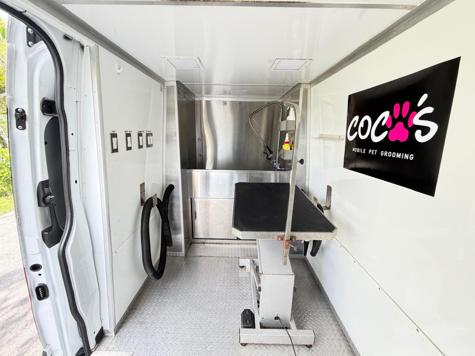 Coco's grooming team with a dog and the mobile van