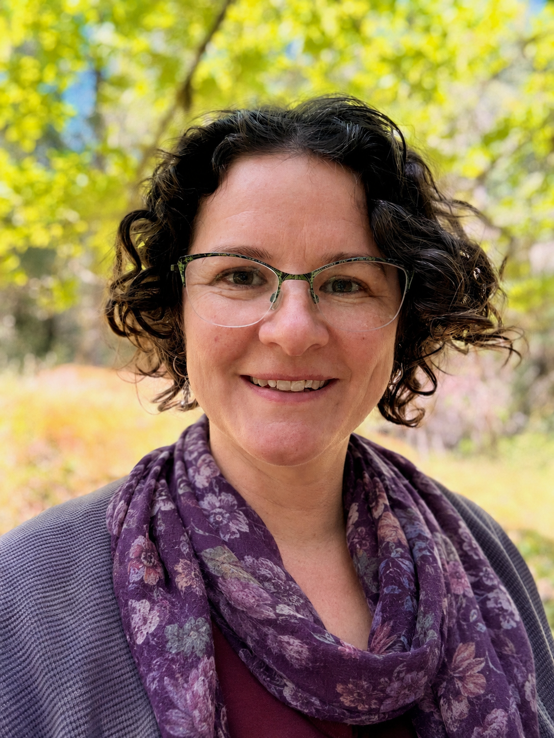Vanya Laporte, Registered Clinical Counsellor, smiling warmly in a nature setting, Victoria, BC.