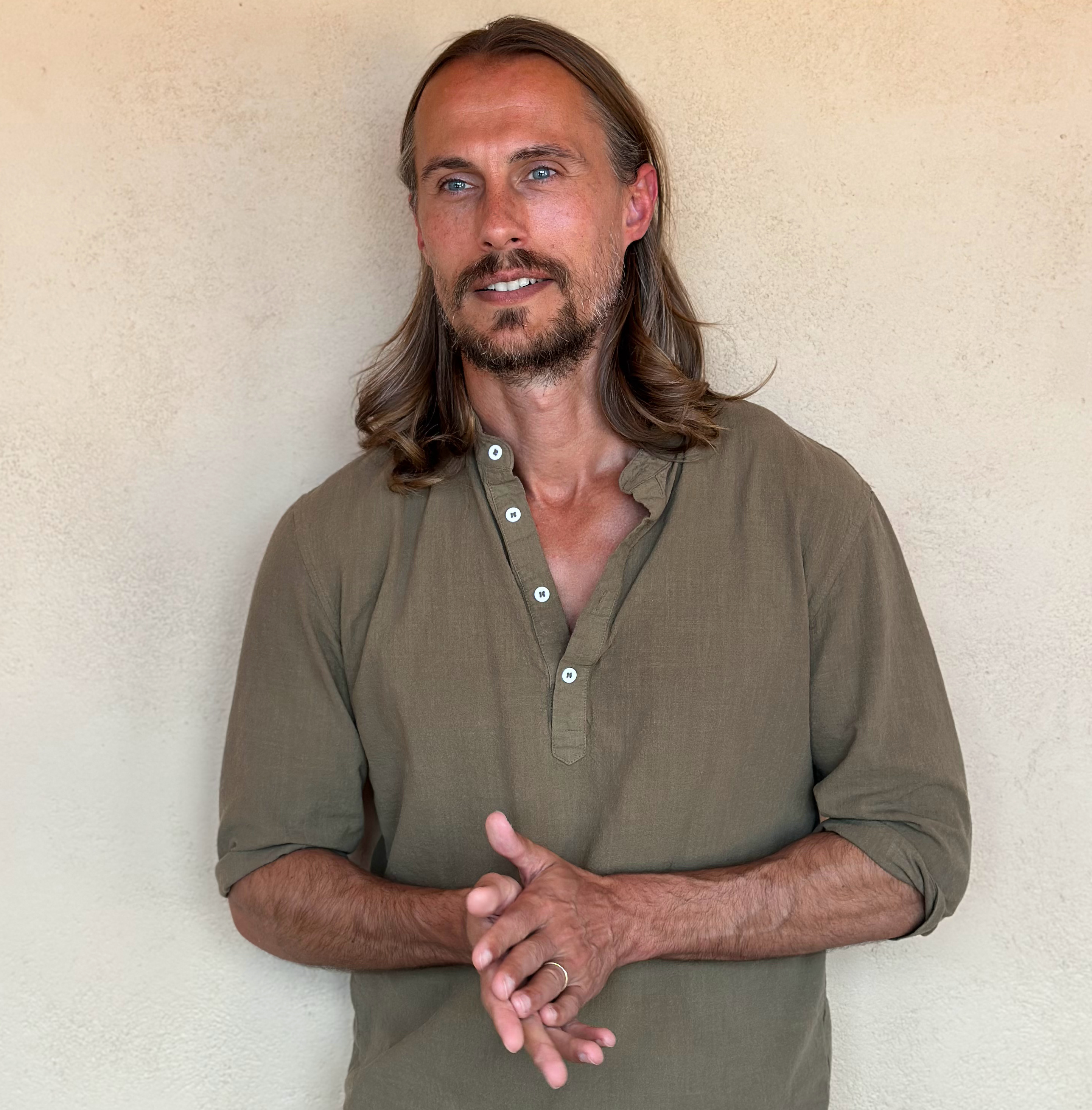Dr. AJ Karlovich seated in meditation outdoors