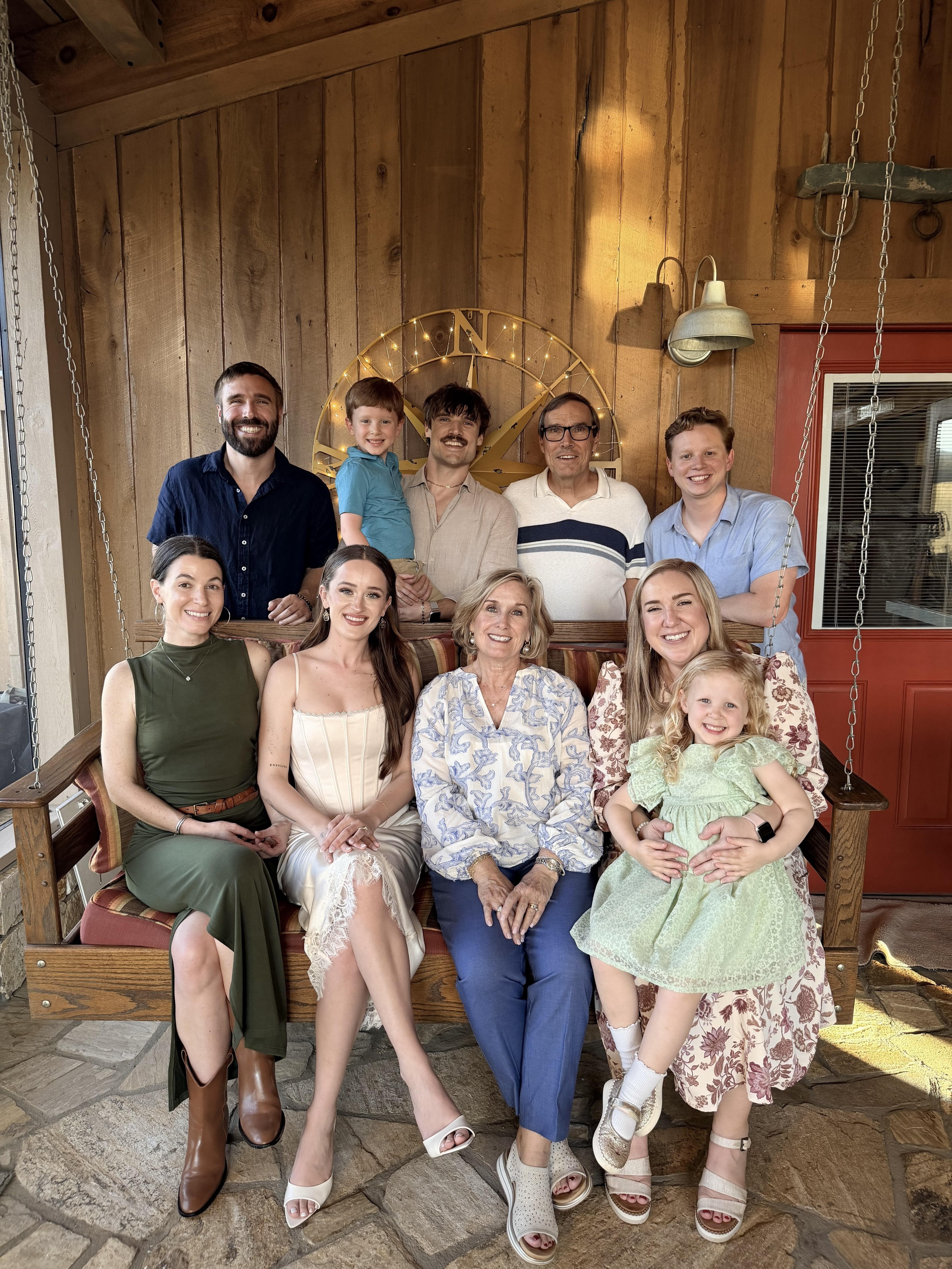 Large family gathered on a porch swing.