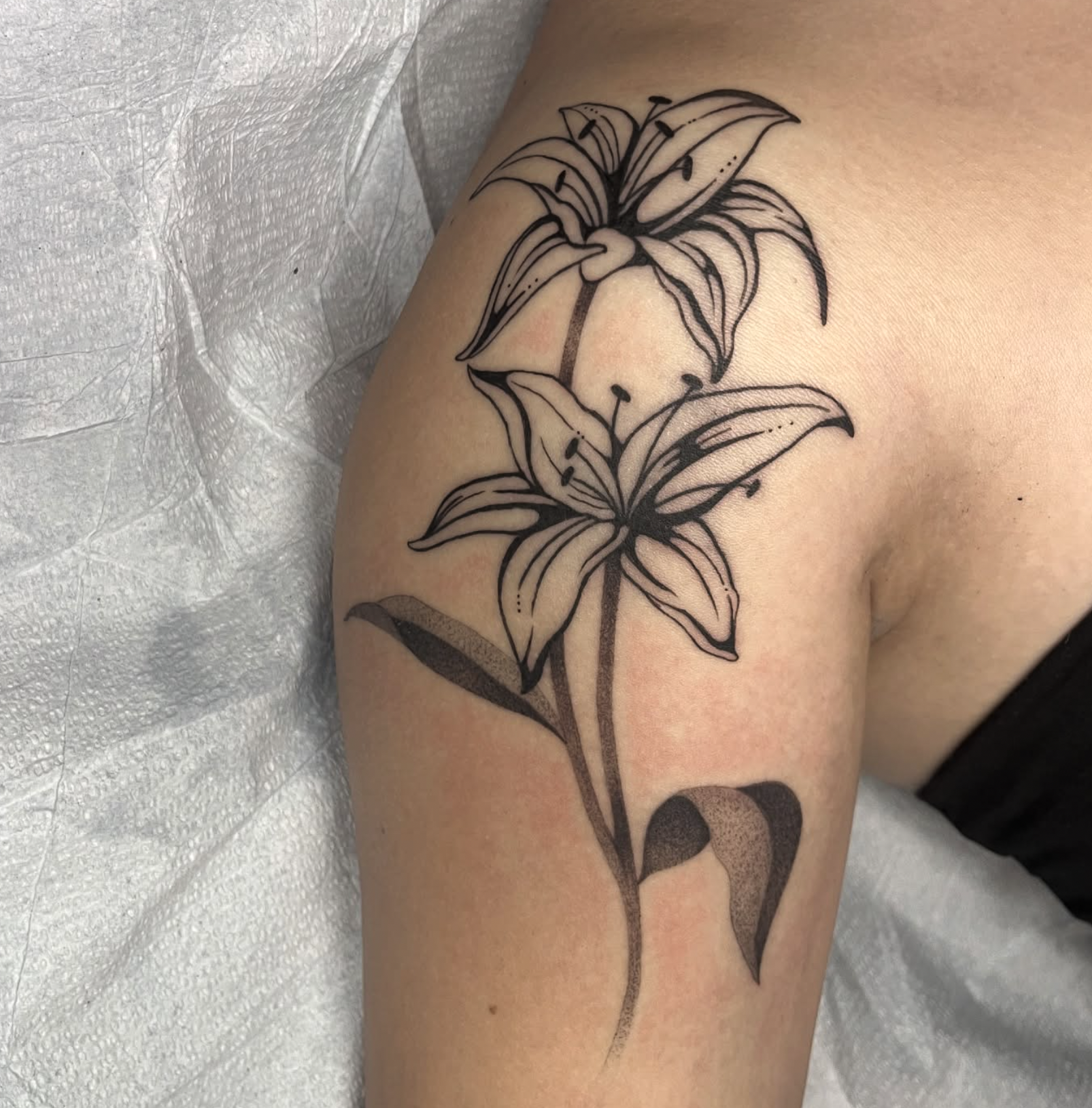 Illustrative blackwork tattoo on arm