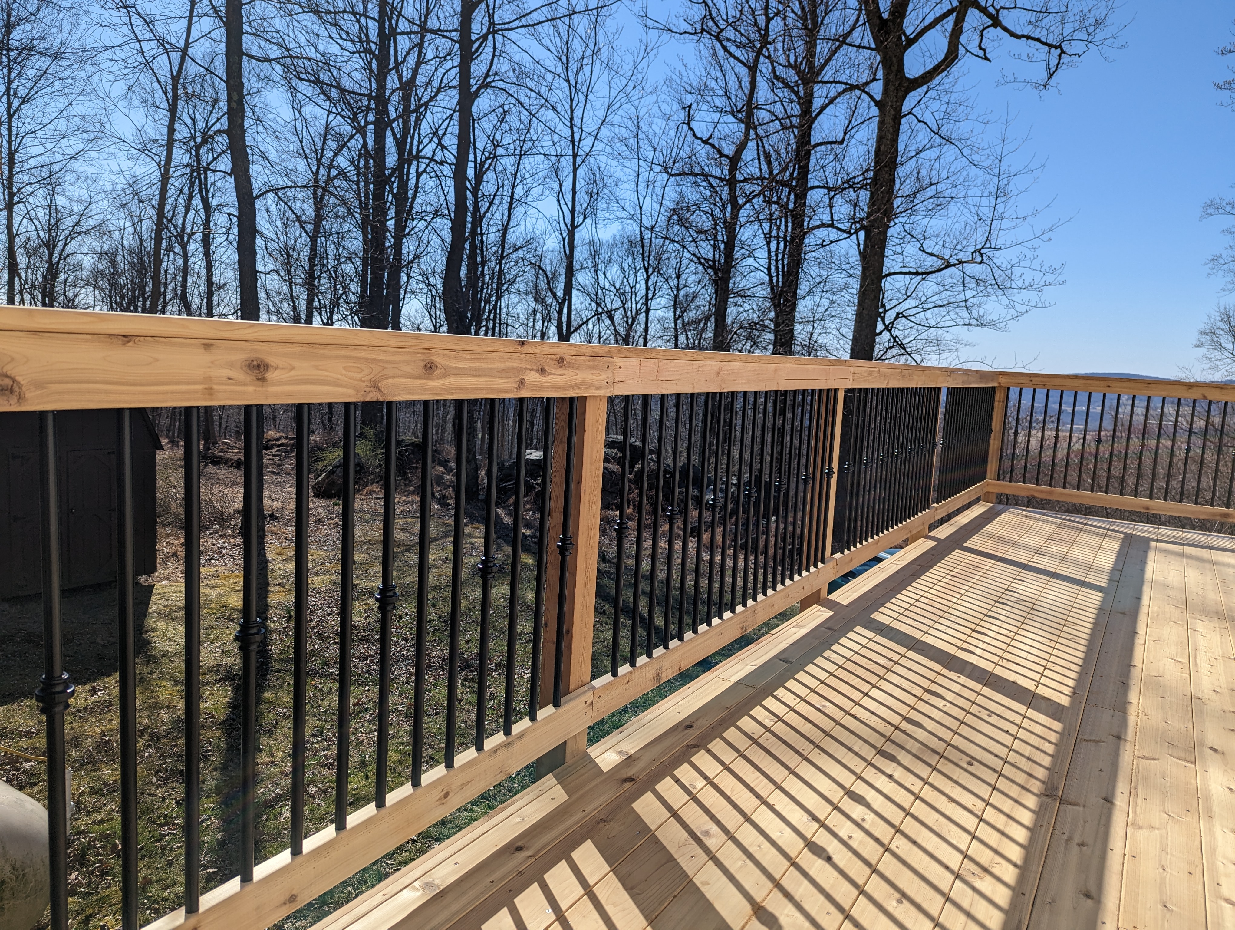 Wood deck surface with black balusters
