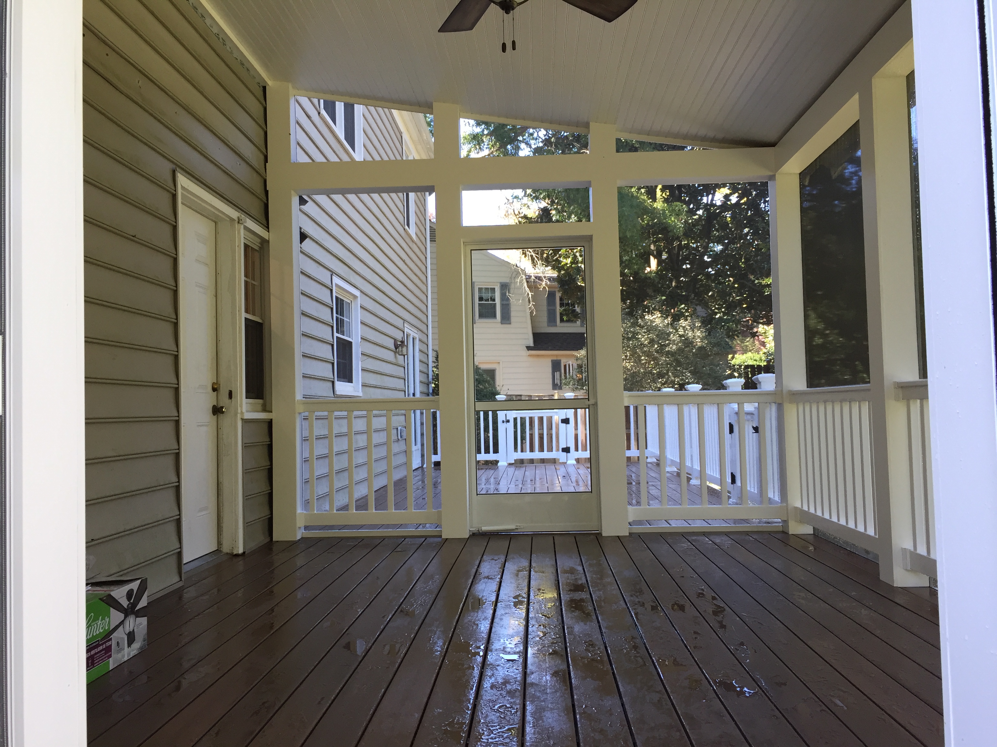 Screened porch interior with ceiling fan