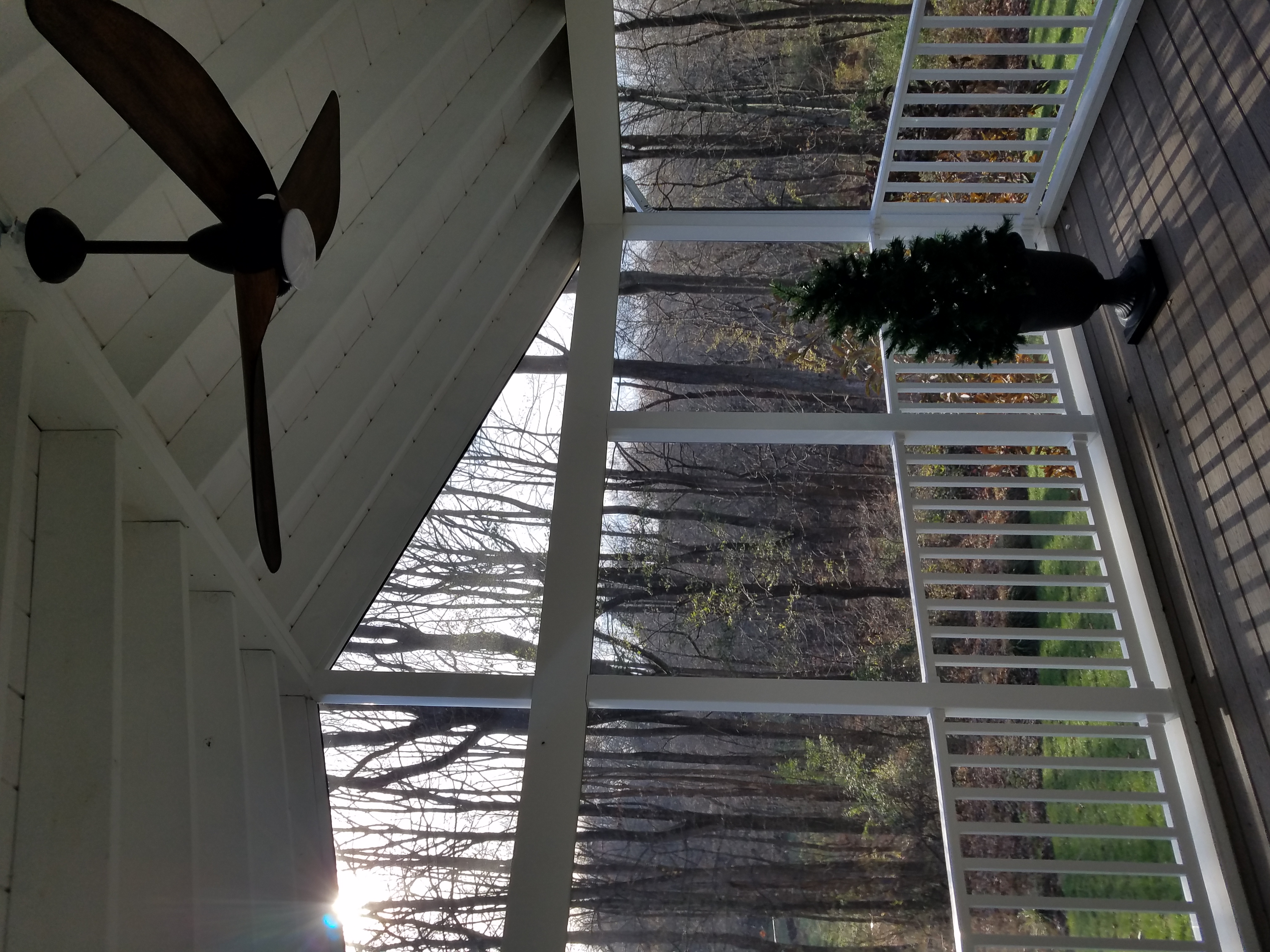 Modern white screened porch with ceiling fan