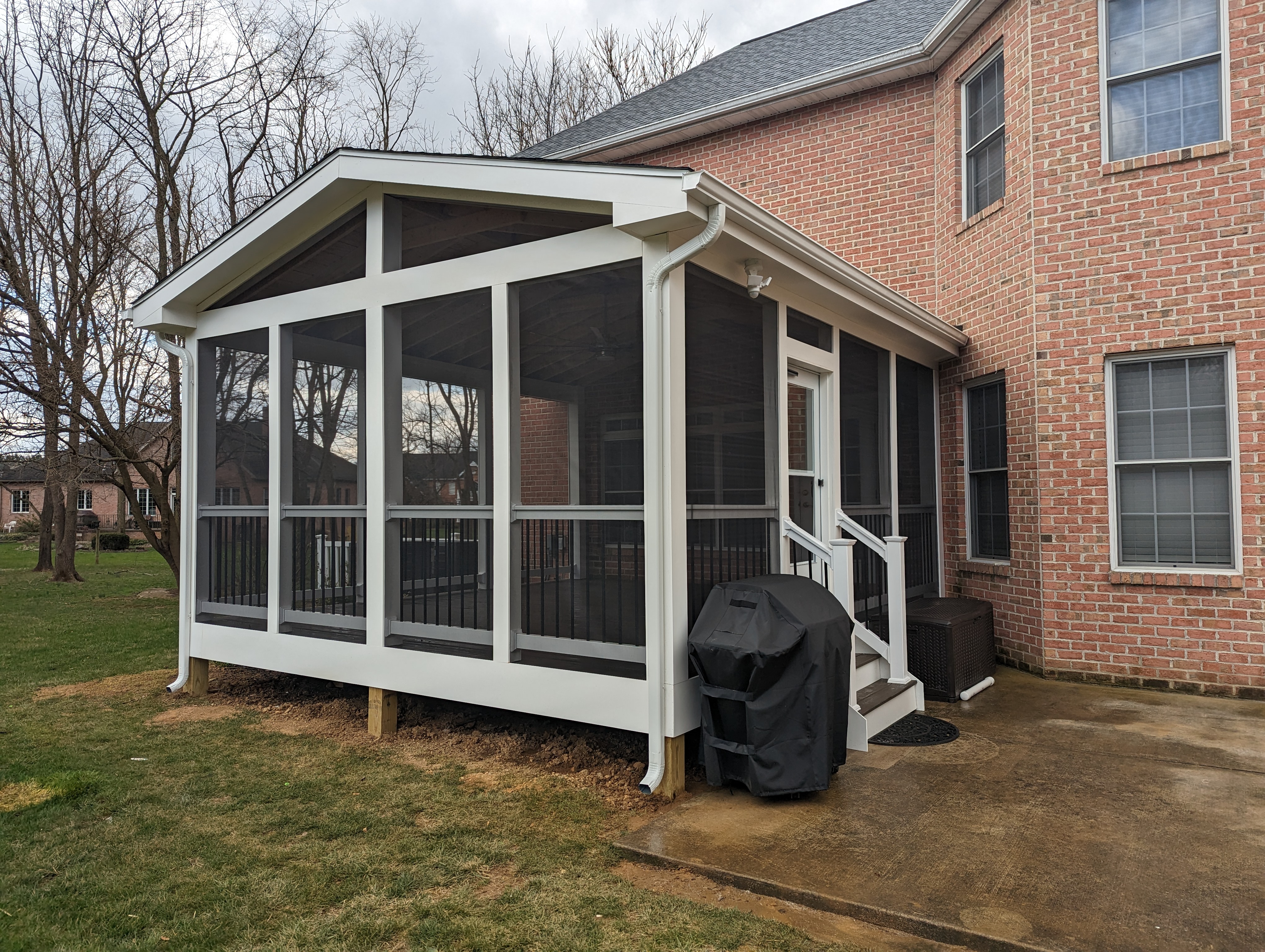 Screened porch addition on brick home