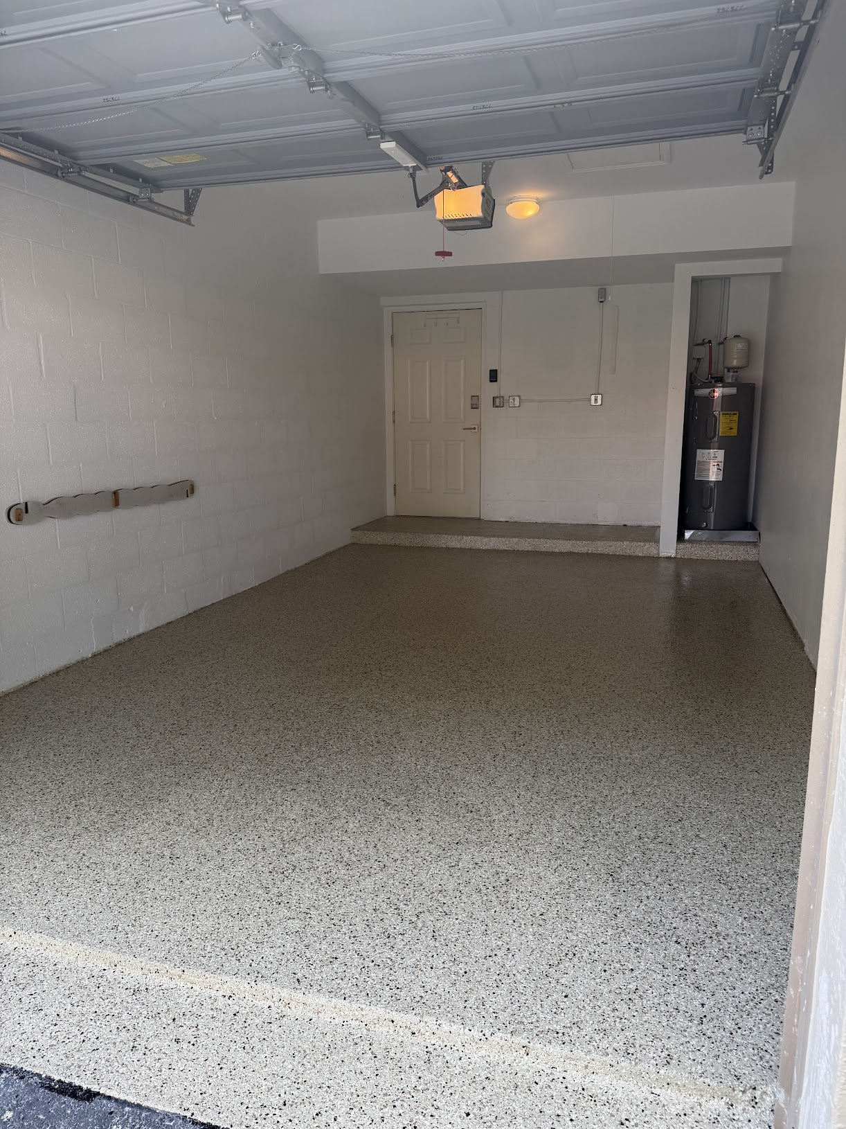 Full garage epoxy flake floor coating with clean white walls