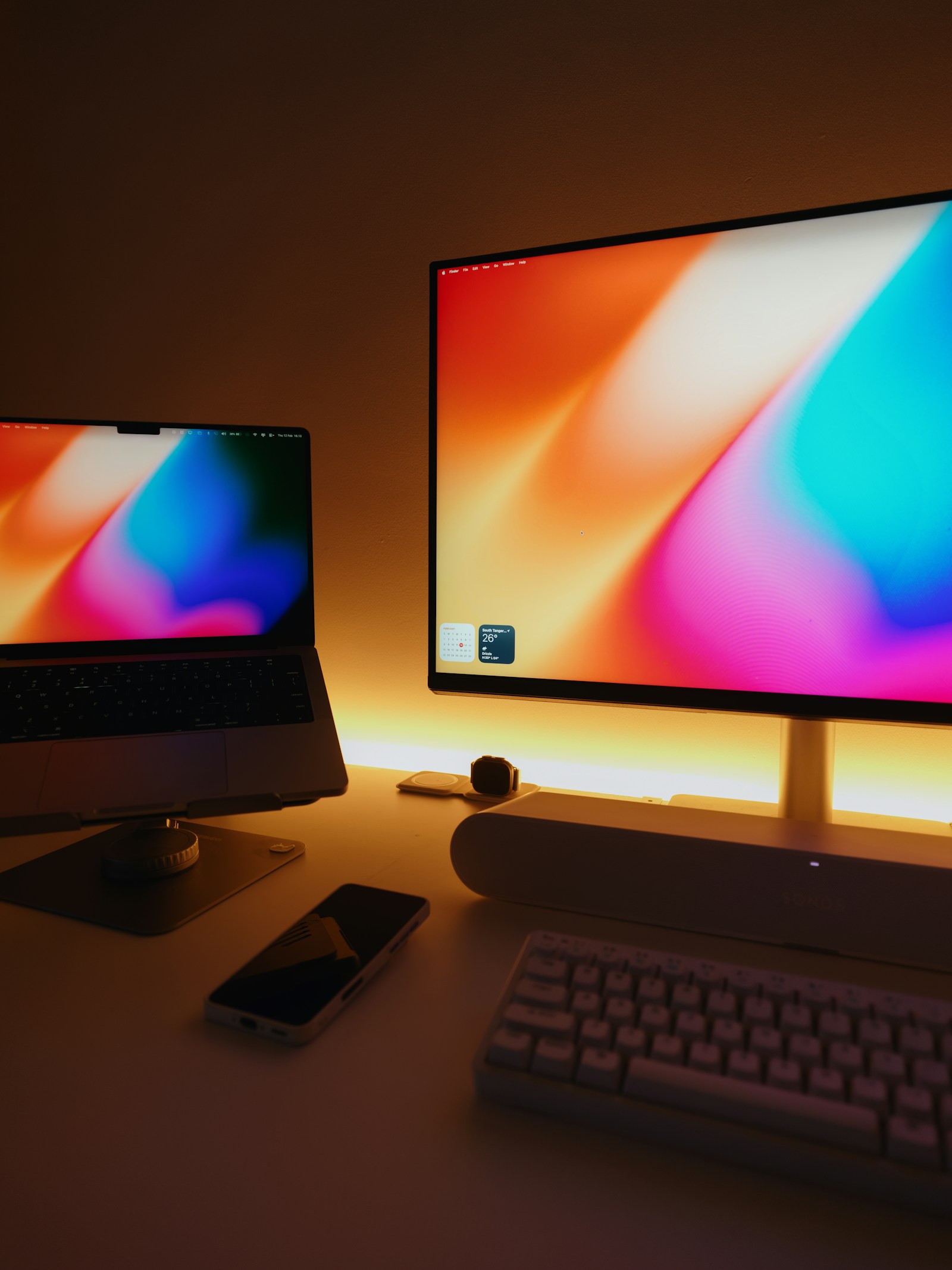 Laptop and monitor on a web design desk