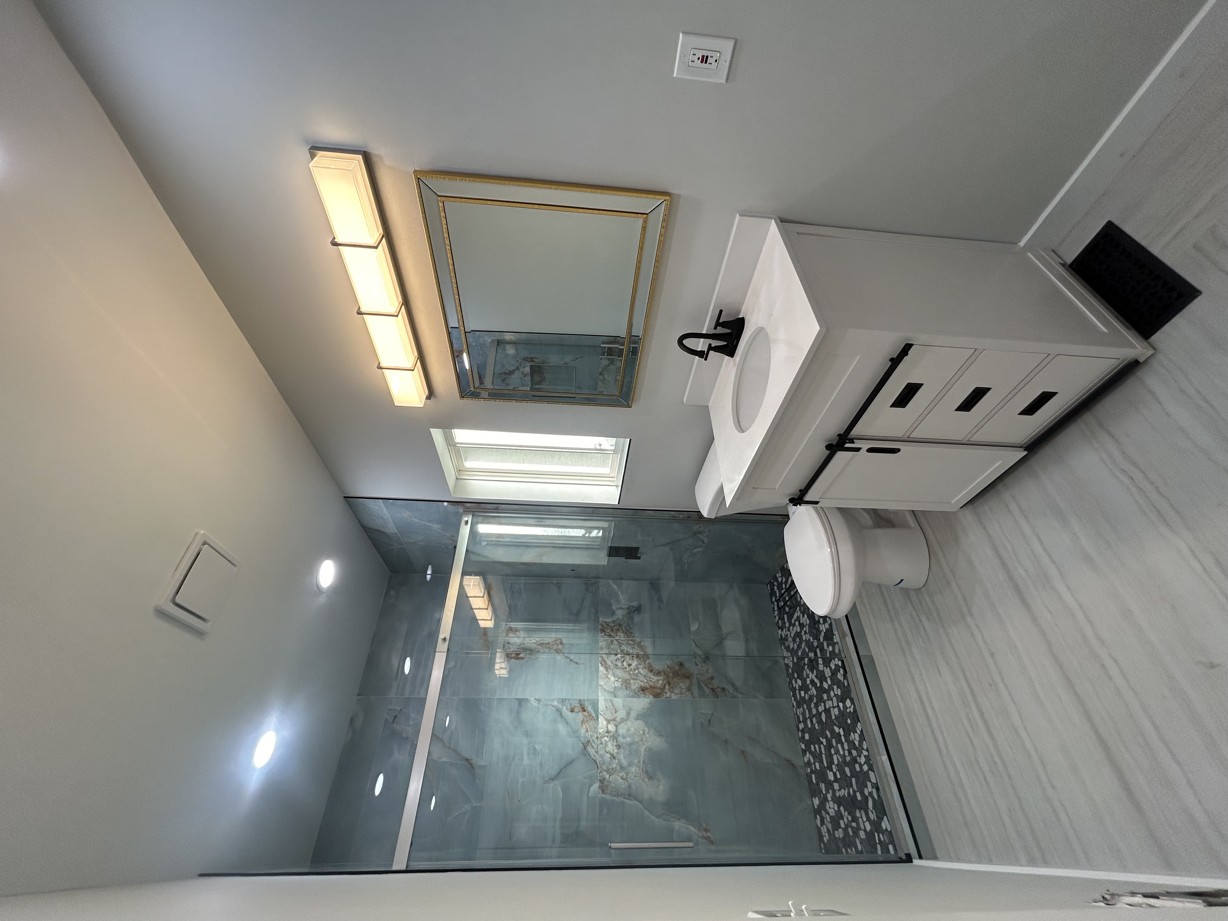 Completed modern bathroom remodeling with marble tile shower and vanity in Portland OR