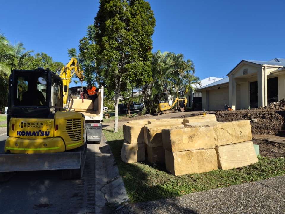 Komatsu excavator with sandstone blocks