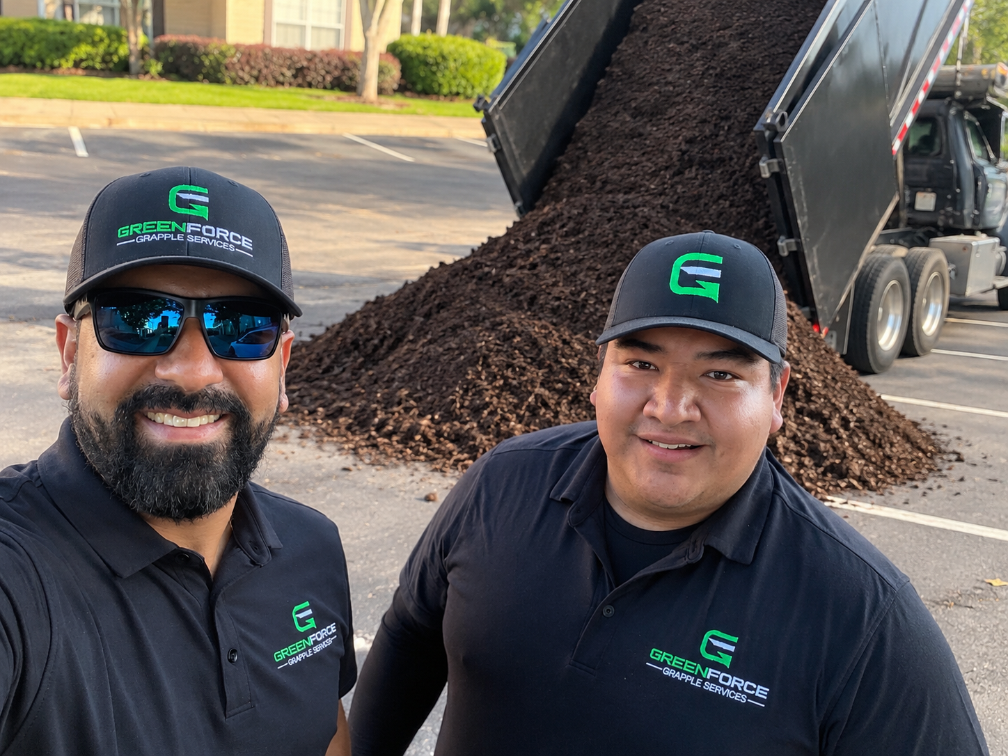 GreenForce team with delivery truck unloading fresh mulch