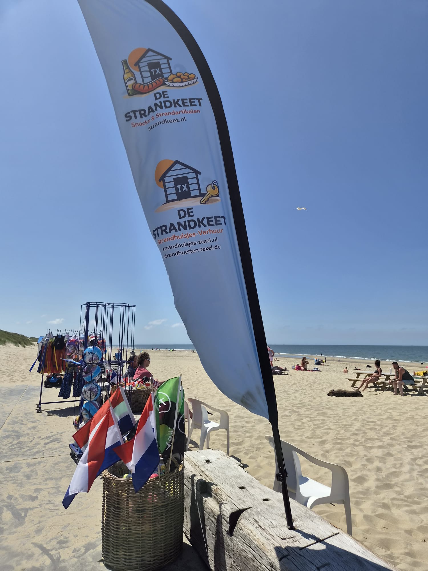 De Strandkeet strandvlag op het zonnige strand van Paal 20